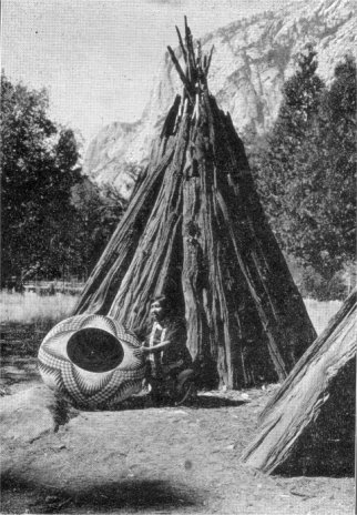 Typical dwelling or u-ma-cha. Mrs. Lucy Telles with large storage basket in foreground
